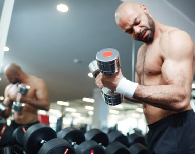 Shirtless Man Lifting Weights During a Gym Workout